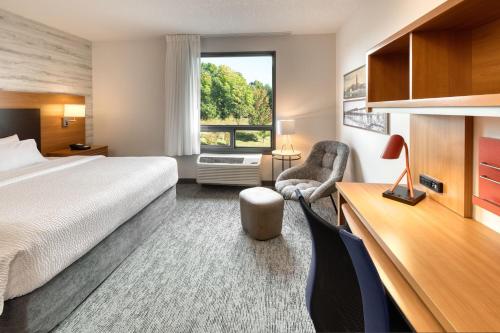 a hotel room with a bed and a desk at TownePlace Suites by Marriott Belleville in Belleville