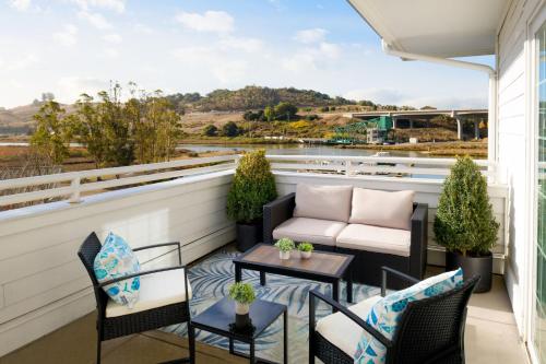 a balcony with a couch and chairs and a table at Sheraton Sonoma Wine Country Petaluma in Petaluma