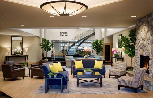 a lobby with couches and chairs and a fireplace at Sheraton Sonoma Wine Country Petaluma in Petaluma