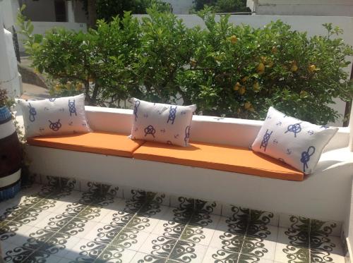 a window seat on a balcony with pillows at Hotel Rodà in Panarea