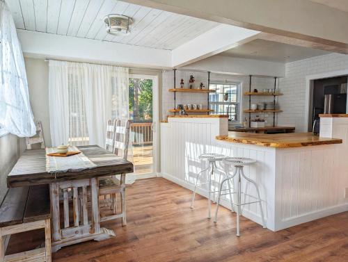 a kitchen with a counter and a table with stools at The Garden House of Downtown Manitou Springs in Manitou Springs