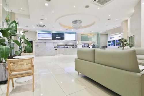 a hospital lobby with a couch and a table at Shire Hotel Seomyeon in Busan