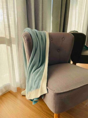 a blanket sitting on the back of a chair at Tide 'n' Seek: Family Beach House with Games Room in Vincentia