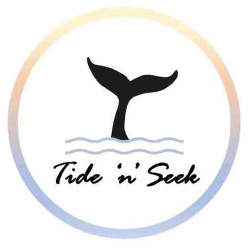 a whale in the water with the words tide seek at Tide 'n' Seek: Family Beach House with Games Room in Vincentia