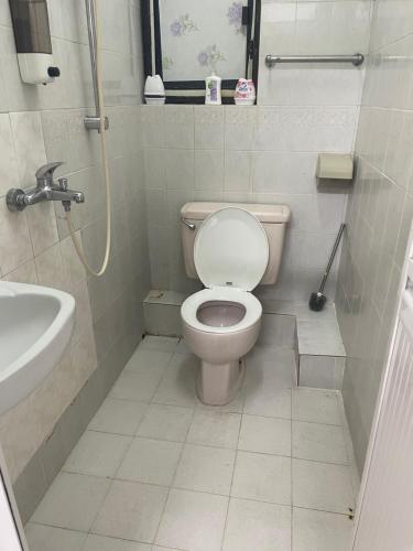 a bathroom with a toilet and a sink at Relaince international guest house in Hong Kong