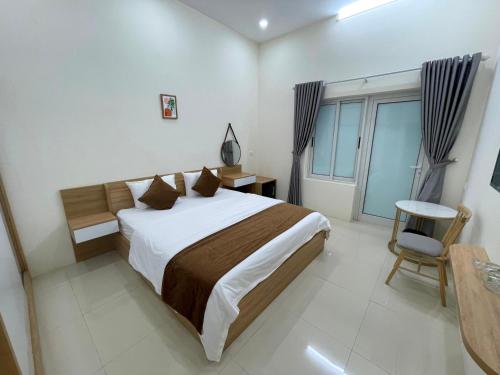 a bedroom with a large bed and a window at Green Hotel Cao Bằng in Cao Bằng