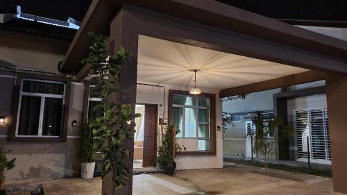 a front door of a house at night at Duyong Damai Homestay by KOWBMAS in Melaka