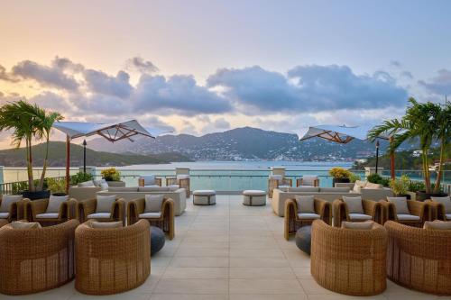 a hotel patio with chairs and a view of the water at The Westin St Thomas Beach Resort & Spa in Frydendal
