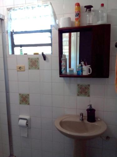 a bathroom with a sink and a mirror and a window at Casa SFX Centro in São José dos Campos
