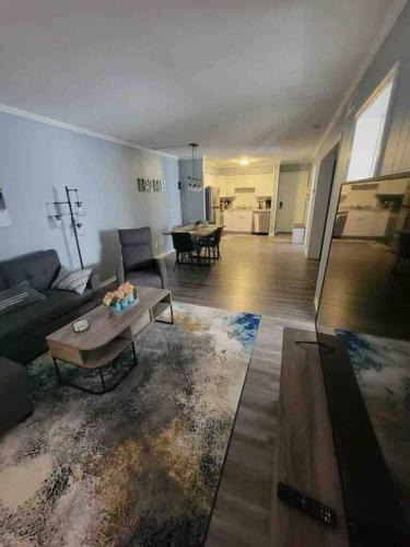 a living room with a couch and a coffee table at 2022 Renovated 2-bdrm cozy, lovely condo w/parking! in Hilton Head Island