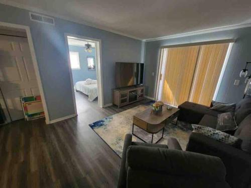 a living room with a couch and a table at 2022 Renovated 2-bdrm cozy, lovely condo w/parking! in Hilton Head Island
