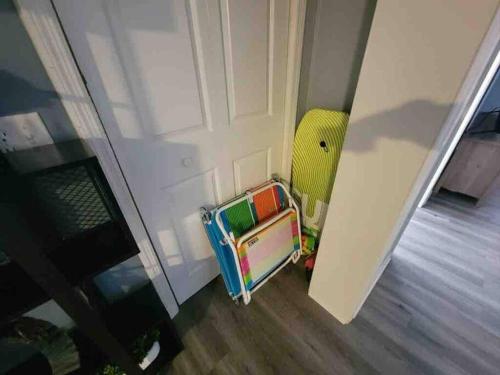 a small childs chair in front of a door at 2022 Renovated 2-bdrm cozy, lovely condo w/parking! in Hilton Head Island