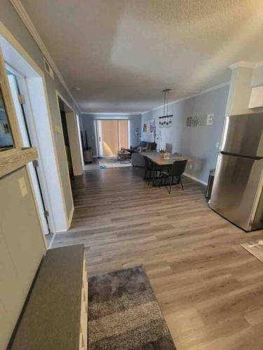 an empty living room with a kitchen and a table at 2022 Renovated 2-bdrm cozy, lovely condo w/parking! in Hilton Head Island