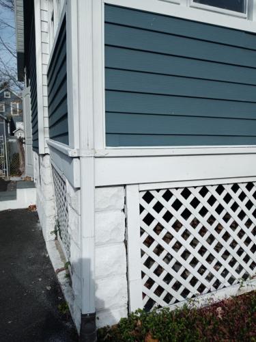 a house with a white fence on the side of it at Cozy Basement Apartment, 40-Min Drive to NY City in Irvington