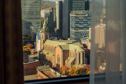 a view of a large building in a city at L7 MYEONGDONG by LOTTE in Seoul