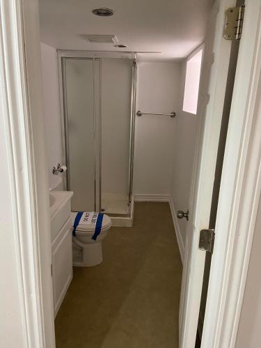 a small bathroom with a toilet and a shower at Downtown closer place for rest in Hamilton