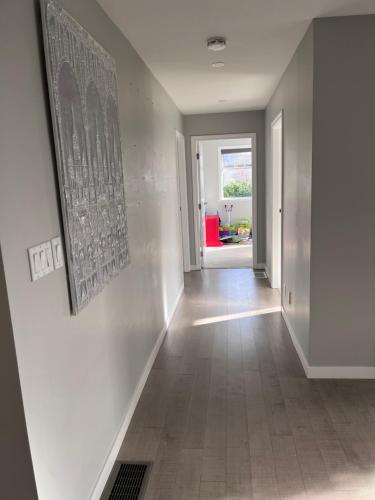 a hallway of a home with a picture on the wall at Quiet Three Bedrooms House in Victoria