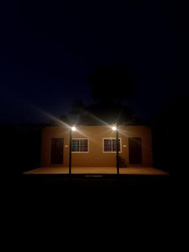 a house with two lights on the side of it at night at Wildlife Retreat in Tāla