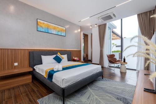 a hotel room with a bed and a table at S8 Aria Resort in Vung Tau