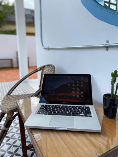 a laptop computer sitting on top of a wooden table at B2 Hotel Savannakhet in Savannakhet