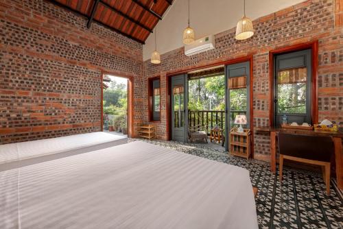 an empty room with a brick wall at LittleTamCoc Boutique Villa Ninh Binh in Ninh Binh