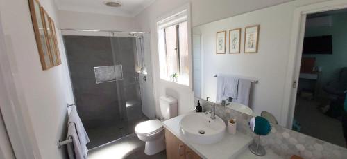 a bathroom with a shower and a toilet and a sink at Private Guest Suite in Lyndhurst in Lyndhurst