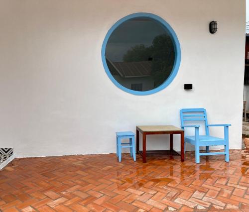 two blue chairs and a table and a mirror at B2 Hotel Savannakhet in Savannakhet