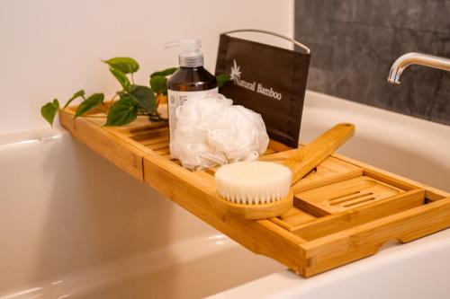 a wooden tray on the side of a bath tub at Premium Apartment Hotel Tokyo East in Tokyo
