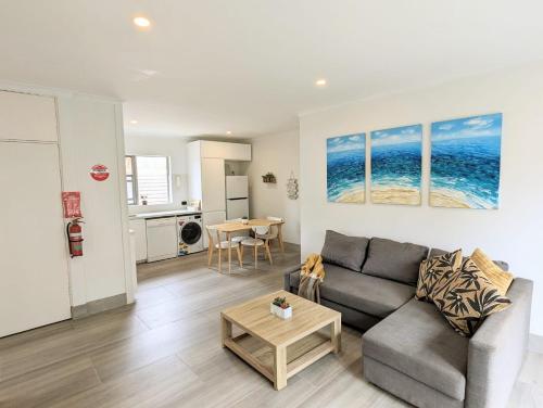 a living room with a couch and a table at Lotus Stay Manly - Apartment 29E in Sydney