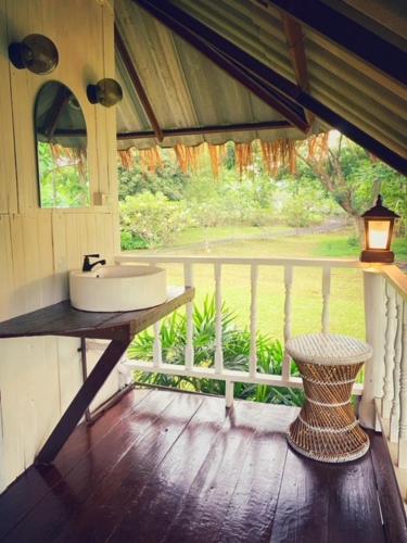 a bathroom with a sink and a window at La Maison - Chiangmai in Mae Taeng
