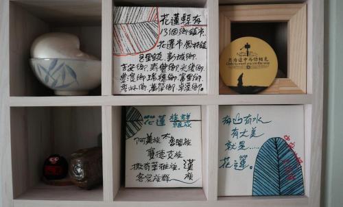 a white cabinet with writing on it at 日日旅樹 Green Stay in Hualien City