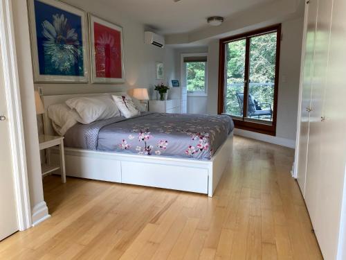 a bedroom with a bed and a window at Superb Beach Home:Heated Pool-Hot Tub Open 365Days in Toronto