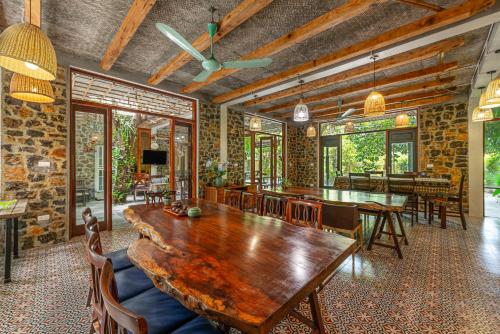 a dining room with a wooden table and chairs at LittleTamCoc Boutique Villa Ninh Binh in Ninh Binh