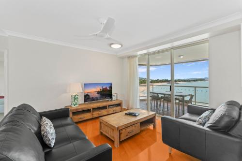 a living room with a couch and a table at Mariners North Holiday Apartments in Townsville