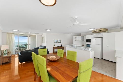 a kitchen and dining room with a table and chairs at Mariners North Holiday Apartments in Townsville