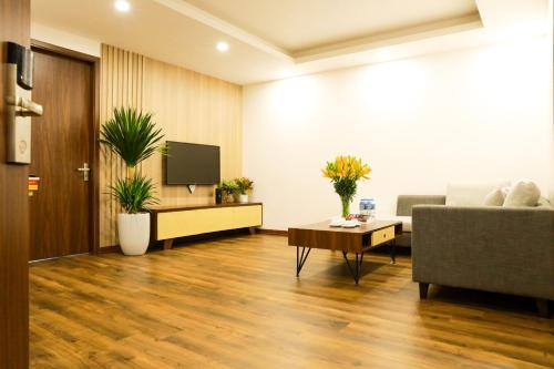 a living room with a couch and a tv at Wins Apartment in Hanoi