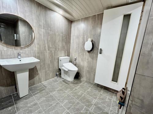 a bathroom with a sink and a toilet and a mirror at Series hotel in Gyeongju