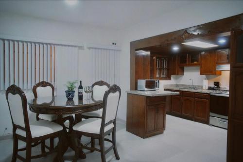 a kitchen with a table and chairs in a kitchen at Casa Macfarland Boutique in Ensenada