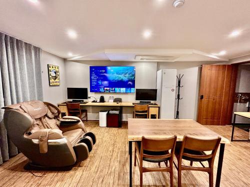 an office with a table and a couch and a desk at Series hotel in Gyeongju