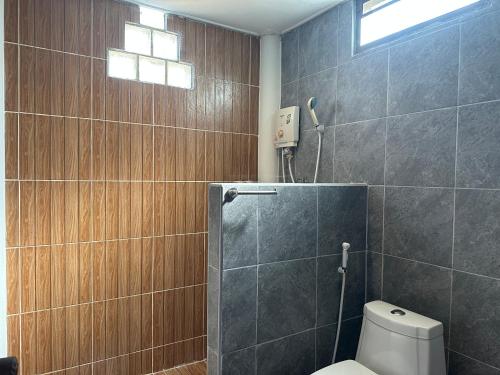 a bathroom with a toilet and a shower at Lanta Garden Home in Ko Lanta