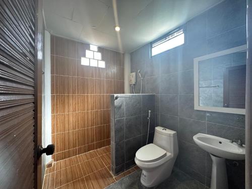 a bathroom with a toilet and a sink at Lanta Garden Home in Ko Lanta