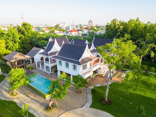 an aerial view of a house with a swimming pool at Phi Private Villa: Luxury Thai with Riverview in Chiang Mai