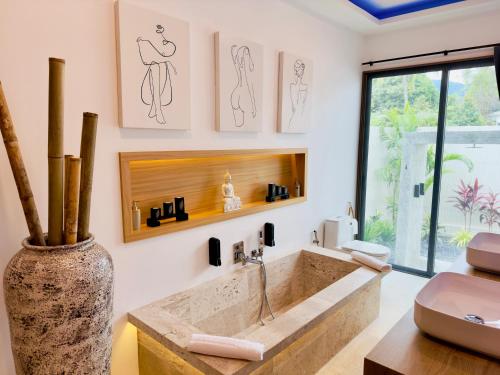 a bathroom with a large sink and a vase at Yuka residence in Koh Samui 