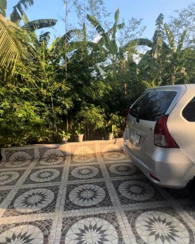 a white car parked on a tiled floor at Charlotte's Vacation Home Busuanga Palawan in Buluang
