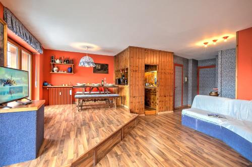 a living room with orange walls and a couch at Terrazza Dei Principi Few Steps From Ski - Happy Rentals in Sestriere