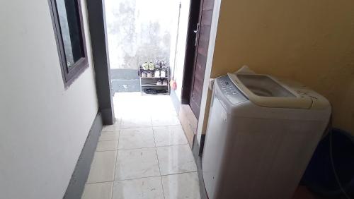 a door leading into a room with a washing machine at Neny's Homestay in Saba