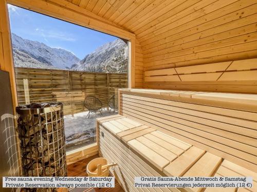 a sauna with a view of the mountains at Alpine Apartments St-Sigmund in Sankt Sigmund im Sellrain