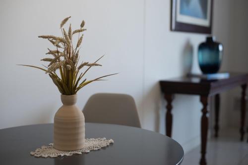 a vase with a plant sitting on a table at Witshire Luxury apartment, Ellipse in Midrand