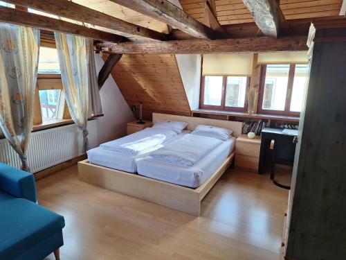 a bedroom with a large bed in a attic at charmante Pension zentral in Reutlingen