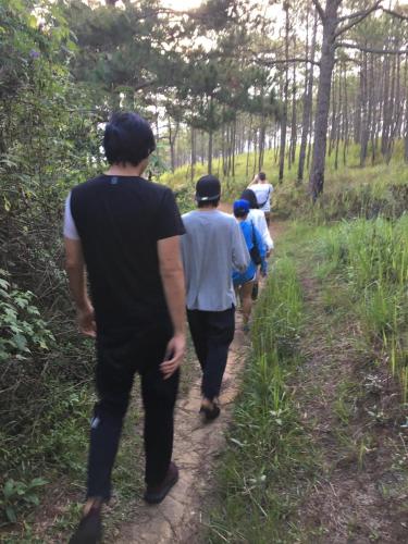 a group of people walking down a trail at Romantic house on a pine hill Dalat in Xuan An